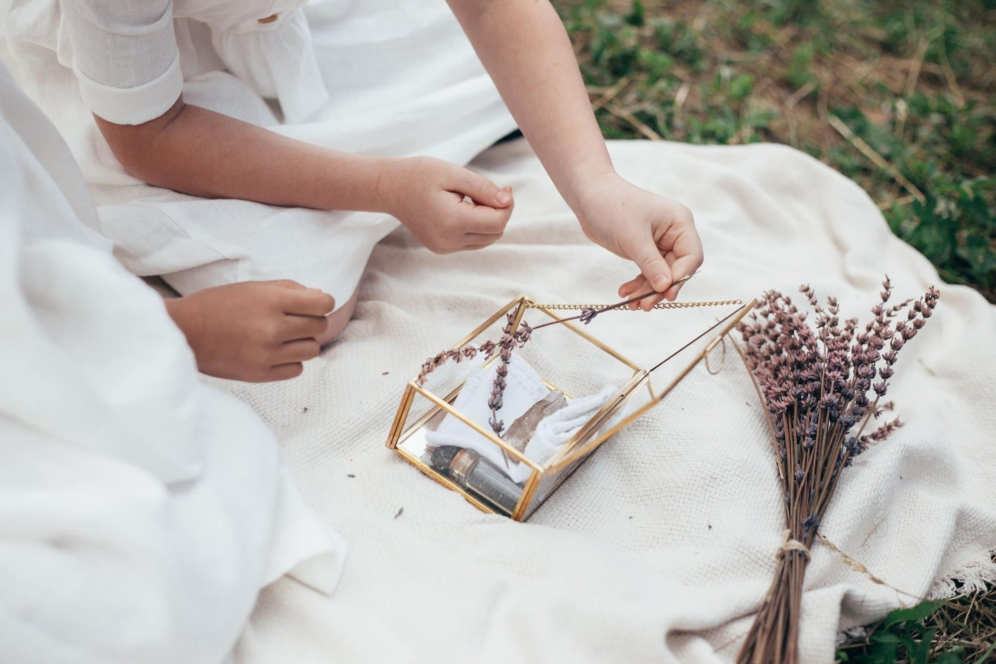 A tender moment, an adult and child's hands touching in warm light